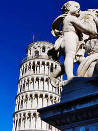 Low angle view of statue against blue sky