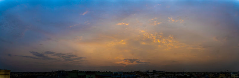 Scenic view of buildings against sky during sunset