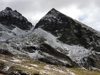 Scenic view of snow covered mountains against sky