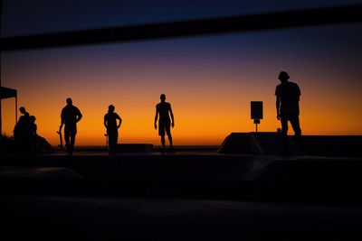 Silhouette people against clear sky during sunset