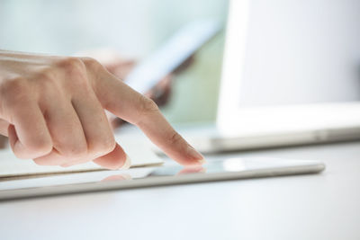 Close-up of woman's hands using digital tablet