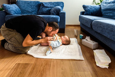 High angle view of father with baby at home