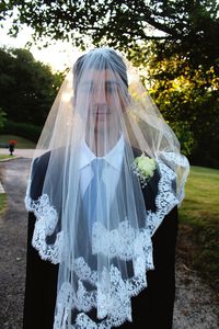 Portrait of man wearing veil while standing on field