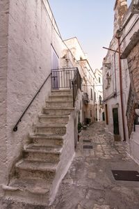 Narrow alley amidst buildings against clear sky