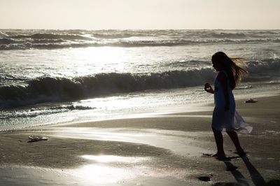 Silhouette of girl on beach