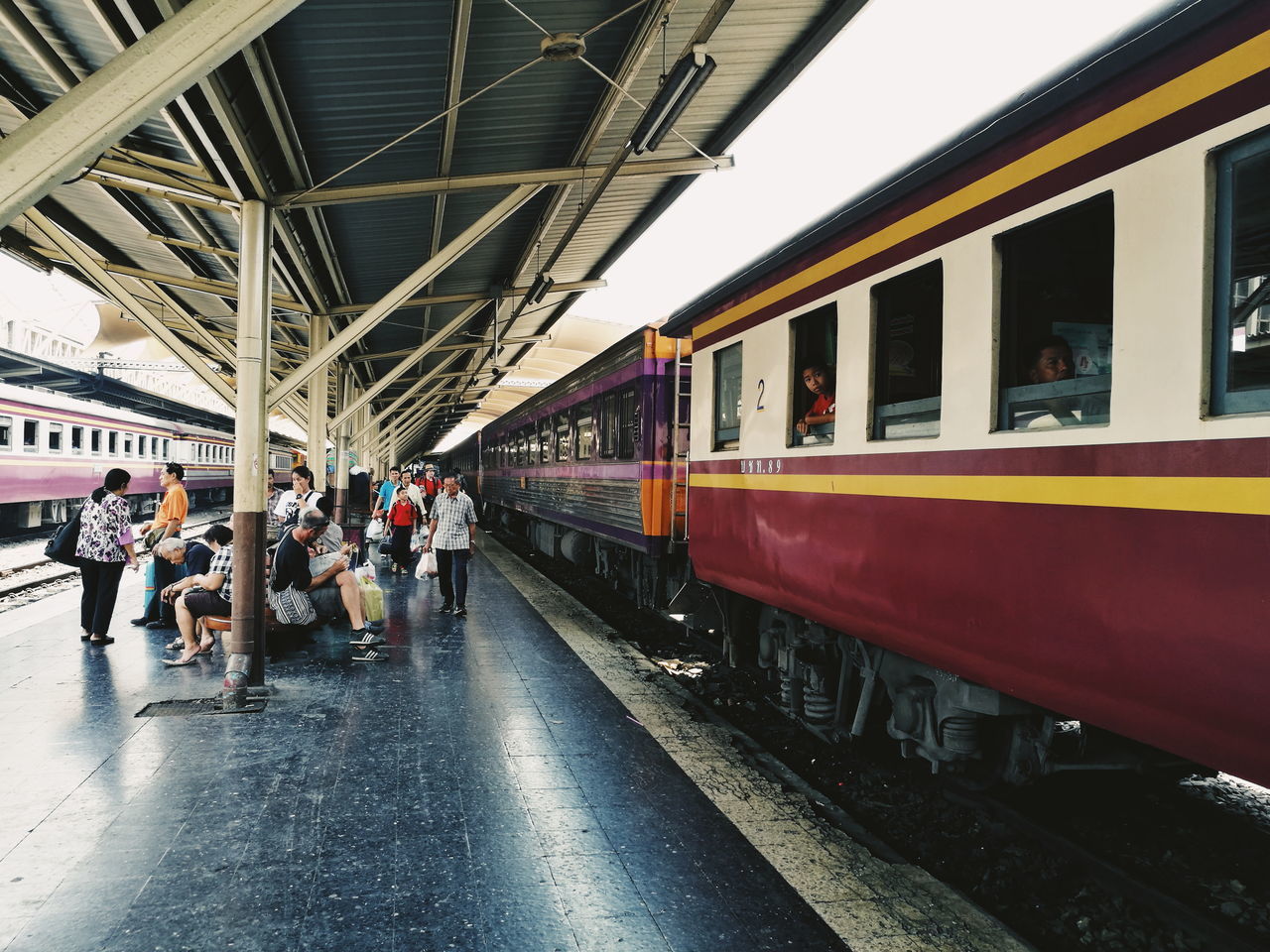 PEOPLE ON RAILROAD STATION PLATFORM