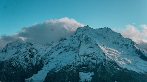 Panoramic view of snowcapped mountains against sky