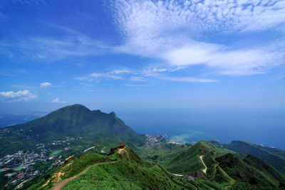 Scenic view of mountains against blue sky