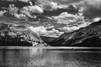 Scenic view of lake by mountains against sky