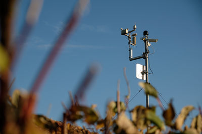 Low angle view of telephone pole against sky