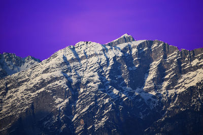 Scenic view of snowcapped mountains against clear sky