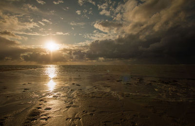 Scenic view of beach against sky during sunset