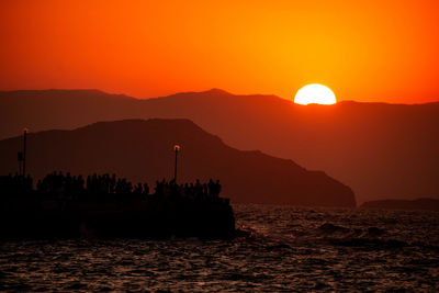 Scenic view of sea against orange sky