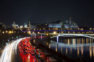 Light trails on road against sky at night