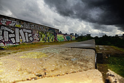 Graffiti on wall against sky