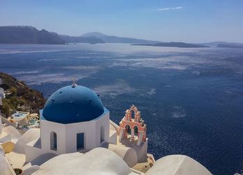 Typical greek white church with sea in the background shot in santorini