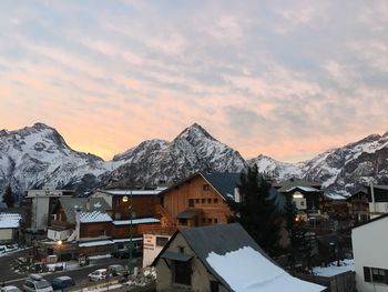 Houses by snowcapped mountain