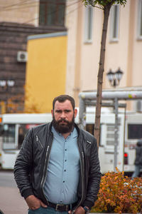 Portrait of man standing in city