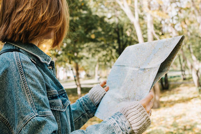 Side view of boy holding paper