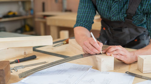 Midsection of man working at workshop