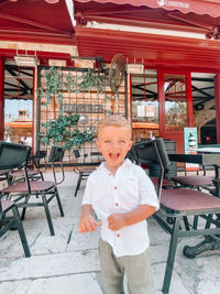 Portrait of smiling boy standing at home