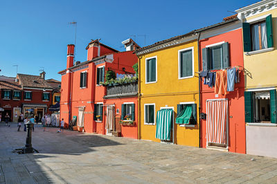 Colorful houses and doors with curtain in burano, a little town full of canals near venice, italy.