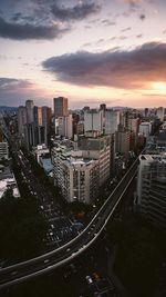 High angle view of street amidst buildings against sky during sunset