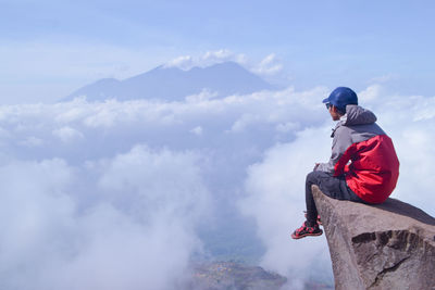 Man standing on mountain against sky