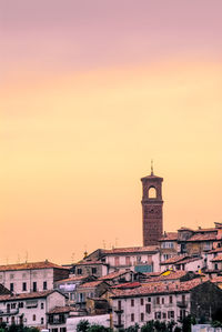 View of buildings in city at sunset