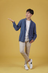 Full length of a young man against white background