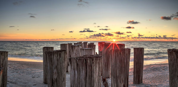 Dilapidated ruins of a pier on port royal beach at sunset in naples, florida