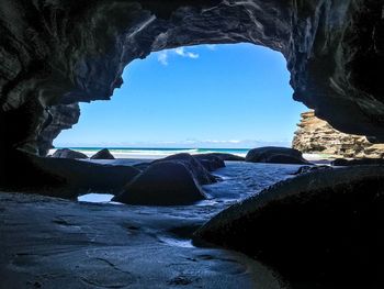 Rock formations in sea against sky