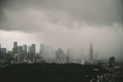 Cityscape against cloudy sky