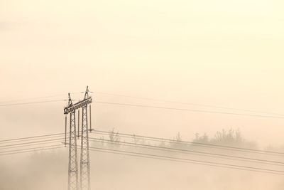 Electric pylon in fog closeup photo