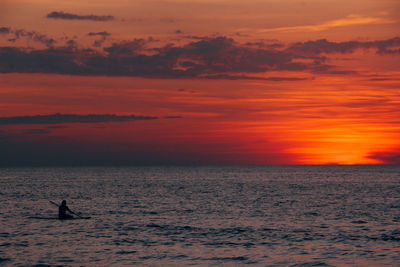 Scenic view of sea against orange sky