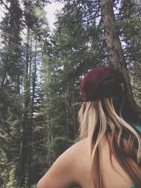 Low angle view of woman standing by tree