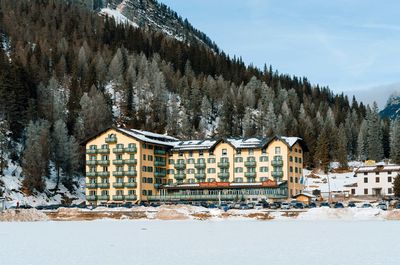 Houses by sea against sky