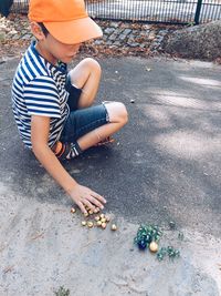 High angle view of boy sitting outdoors