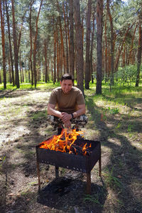 Rear view of man standing in forest