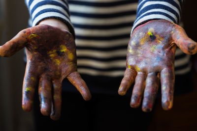 Midsection of person showing messy hands