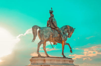 Low angle view of statue against sky