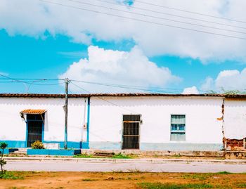 Buildings against cloudy sky