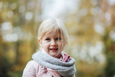 Portrait of cute girl smiling outdoors