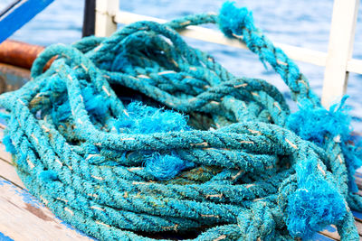 Close-up of blue rope tied to pier