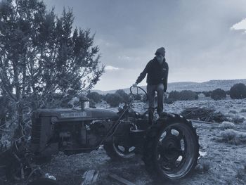 Rear view of man with bicycle standing on mountain