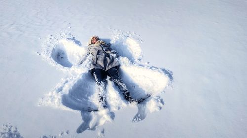 High angle view of person making snow angel