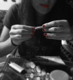 Cropped image of woman holding cigarette