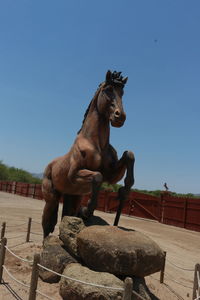 Statue of horse against clear sky