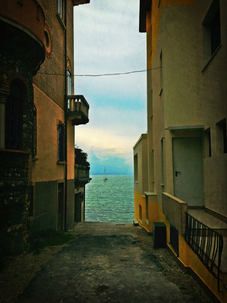 architecture, built structure, water, building exterior, sea, sky, cloud - sky, railing, horizon over water, cloud, house, cloudy, the way forward, outdoors, residential structure, nature, building, no people, residential building, tranquility