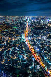 High angle view of illuminated city buildings at night